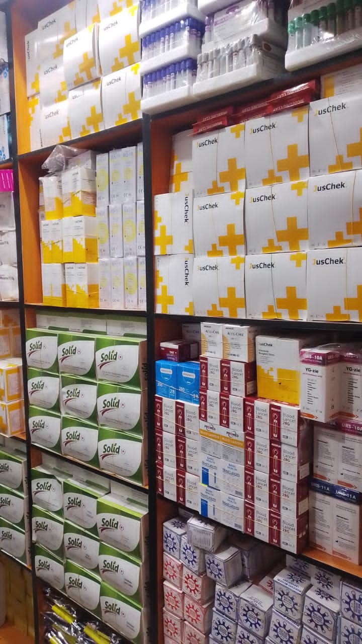 Shelves stocked with rapid test kits and lab consumables at Kingschoice Med & More